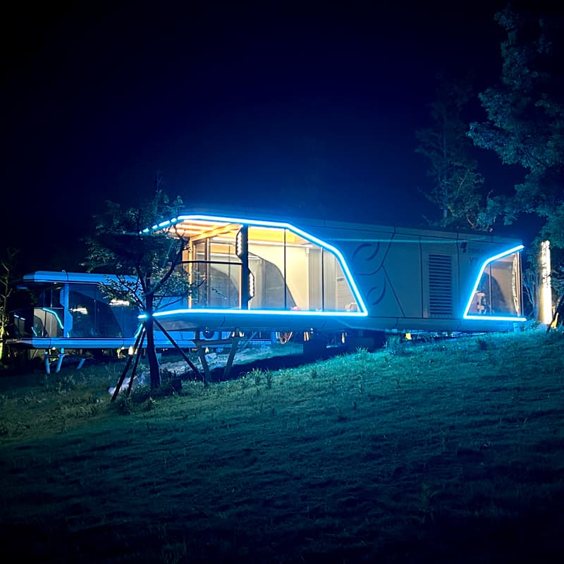 Yinneng Y7 capsule homestay at night with illuminated facade