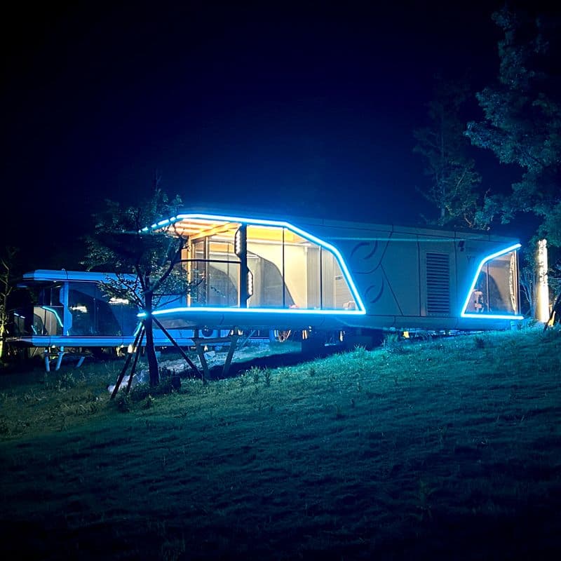 Yinneng Y7 capsule homestay at night with illuminated facade